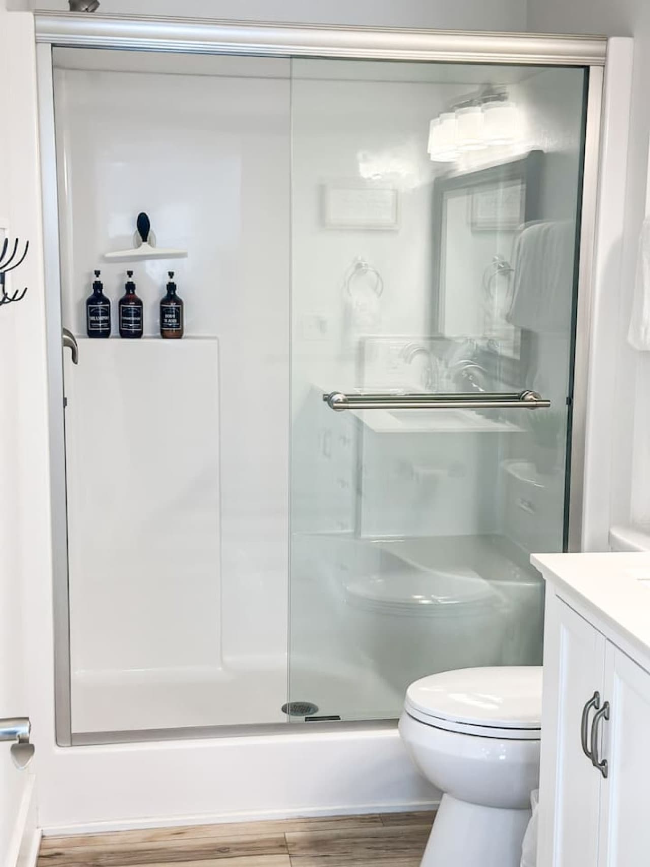 Upper level bathroom offers a walking shower with rain showerhead.