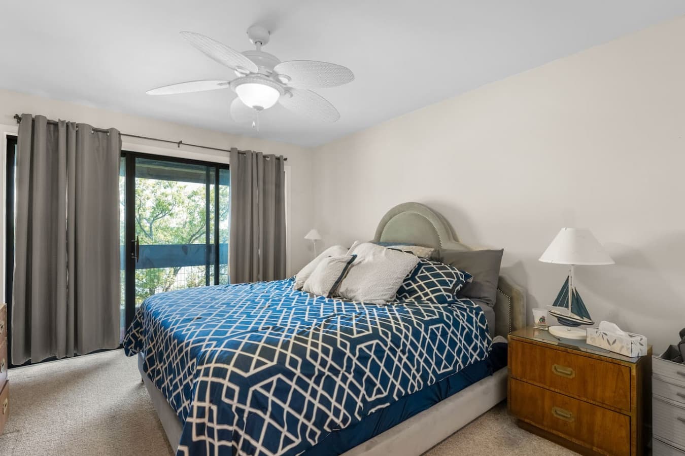 "Wake up refreshed! This comfortable bedroom offers direct access to outdoor views, letting in natural light and fresh air."