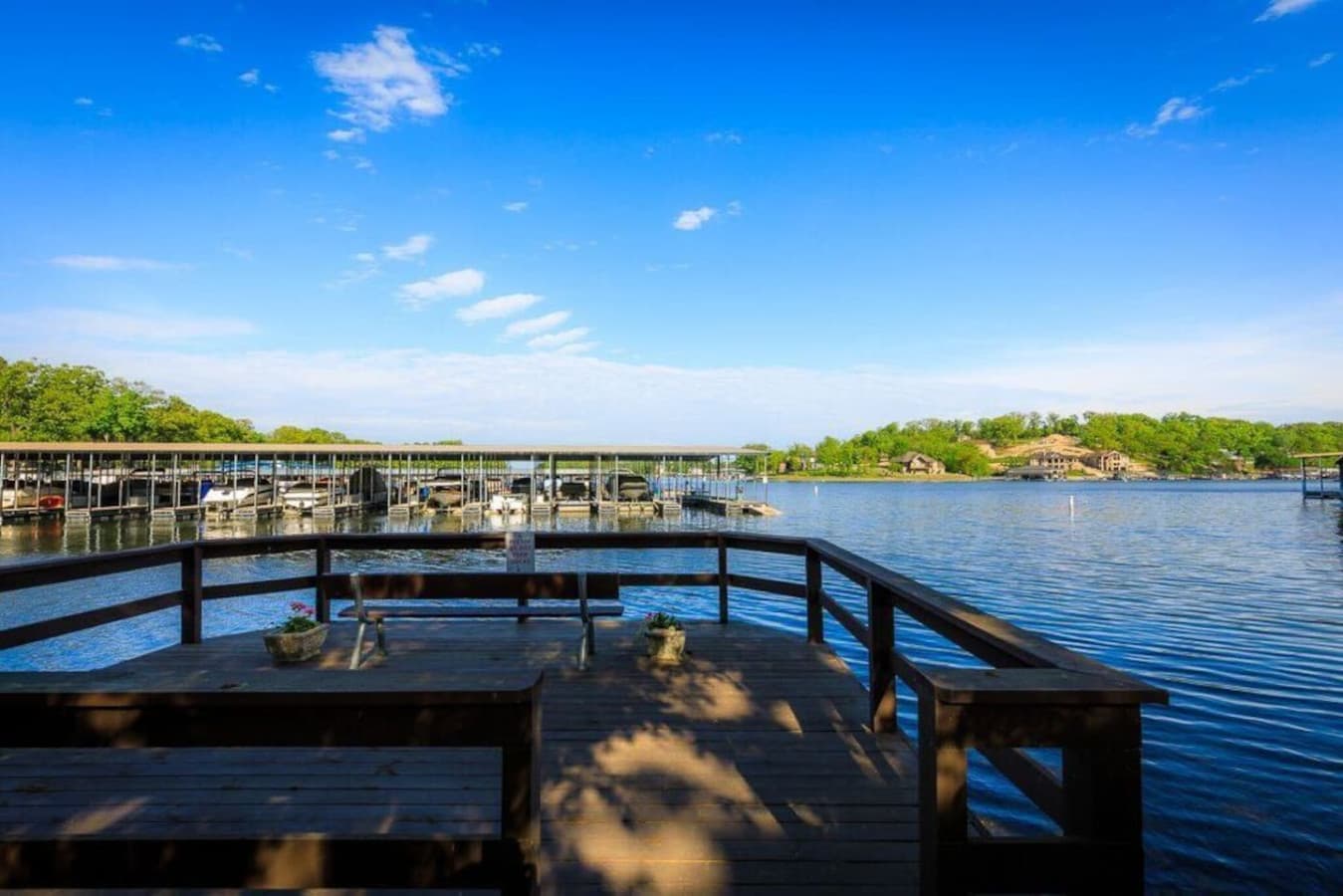 Enjoy a stunning view of the serene lake from the cozy deck, perfect for a relaxing afternoon.  This public swimdeck is part of the Knolls complex and available for guest use.