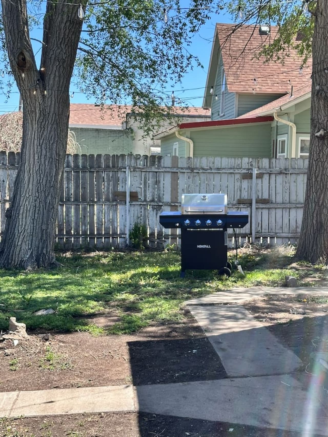 Enjoy this peaceful Airbnb backyard with grill and shaded seating, perfect for cookouts, weekend getaways, and group stays close to dining, shopping, and local attractions.