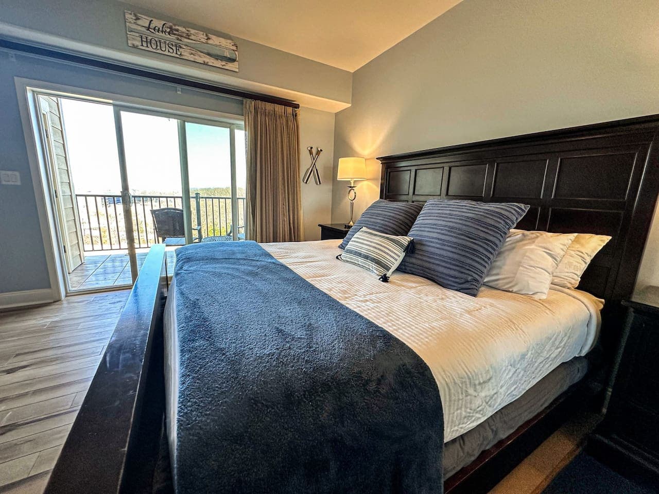 A King master bedroom with direct access to outdoor seating and scenery.