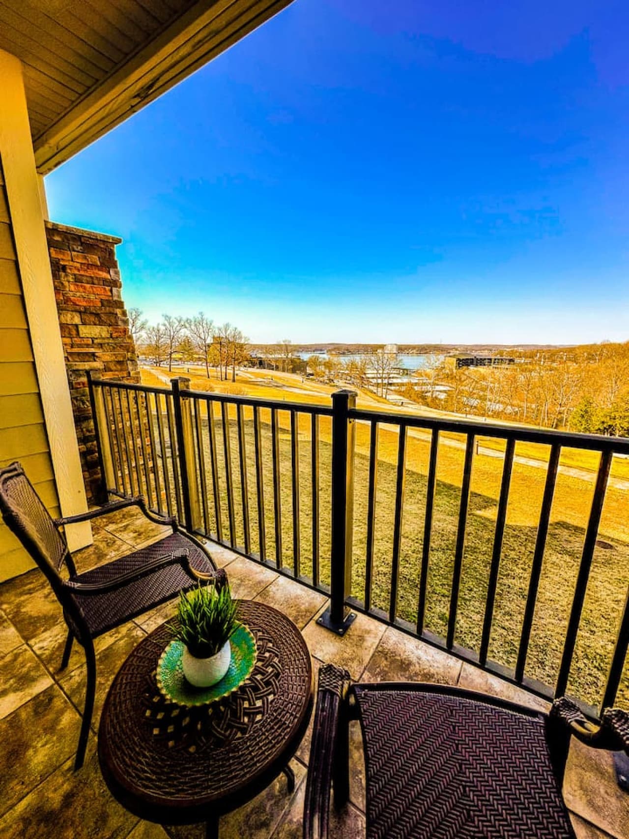 A private balcony with seating and a view of the lake.