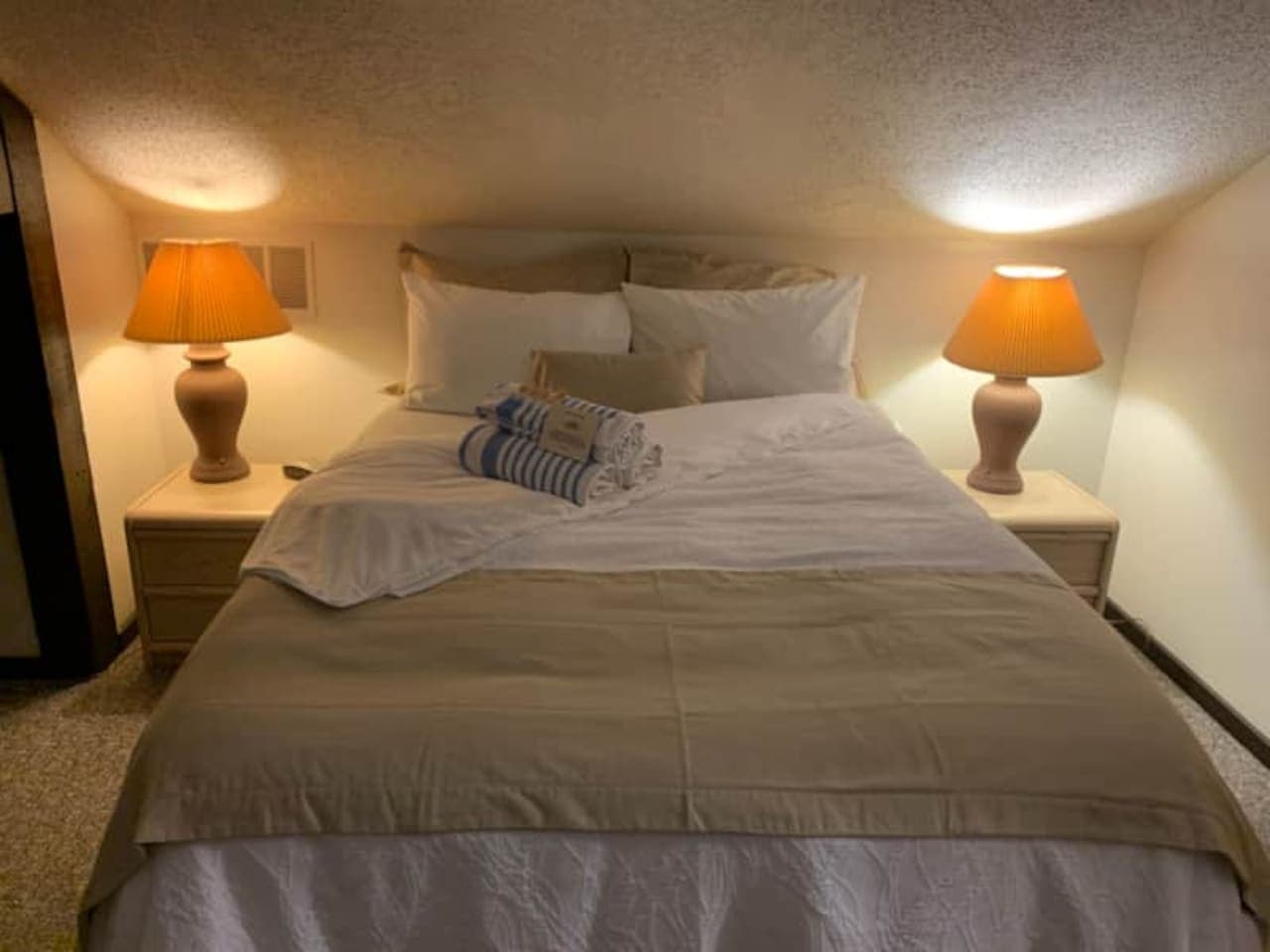Sink into ultimate comfort in this cozy bedroom. Soft lighting sets the mood for a truly serene night's sleep.