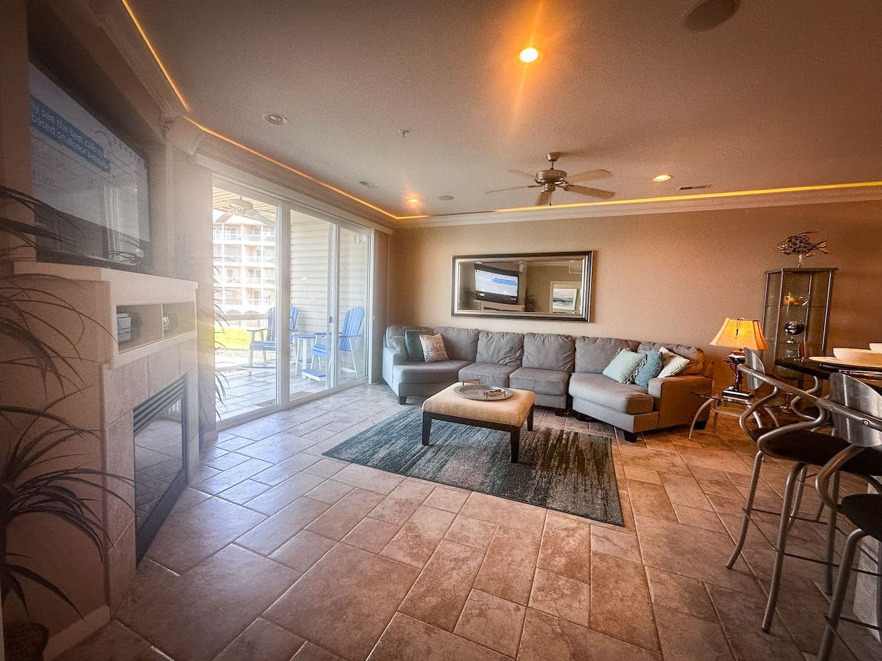 This spacious living area, complete with a cozy fireplace and large smart TV, is perfect for movie nights or simply enjoying the lake views.