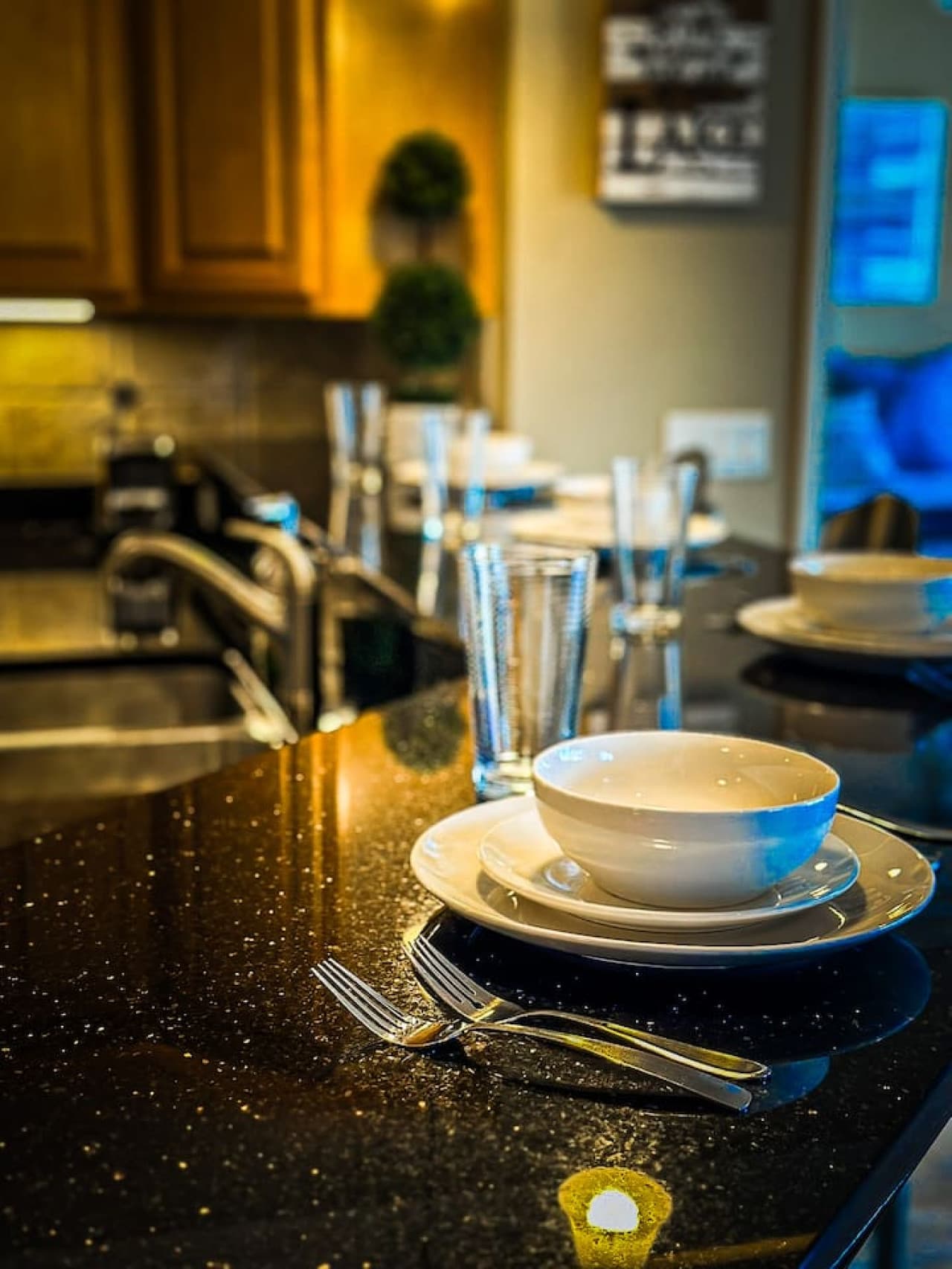 This well-appointed dining area seamlessly connects to the kitchen and living space, fostering an open and inviting atmosphere for entertaining. Enjoy meals at the elegant dining table, or grab a quick bite at the adjacent breakfast bar, all within s