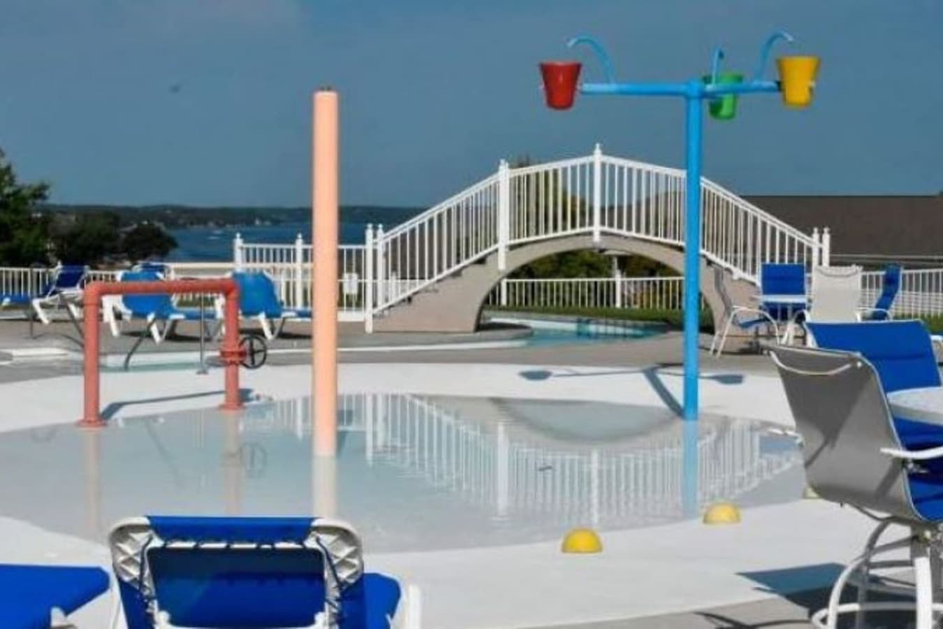 This expansive multi-level swimming pool area offers a refreshing oasis with ample lounge chairs for sunbathing and relaxation. Kids will love the interactive splash pad, featuring colorful water sprayers and tipping buckets for endless fun.