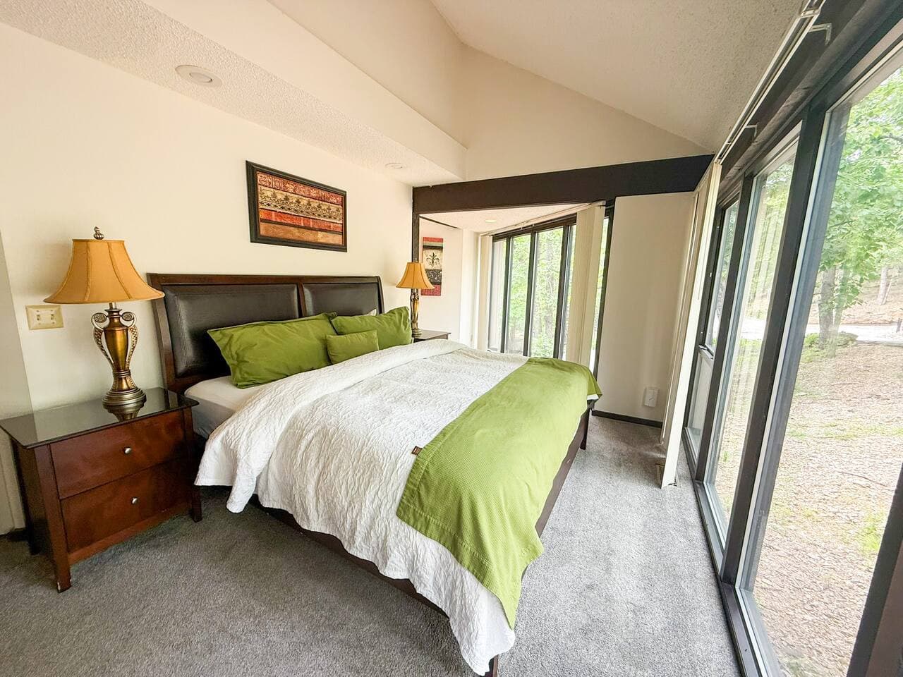 Let the forest be your backdrop—cozy up in this serene and naturally lit bedroom retreat.