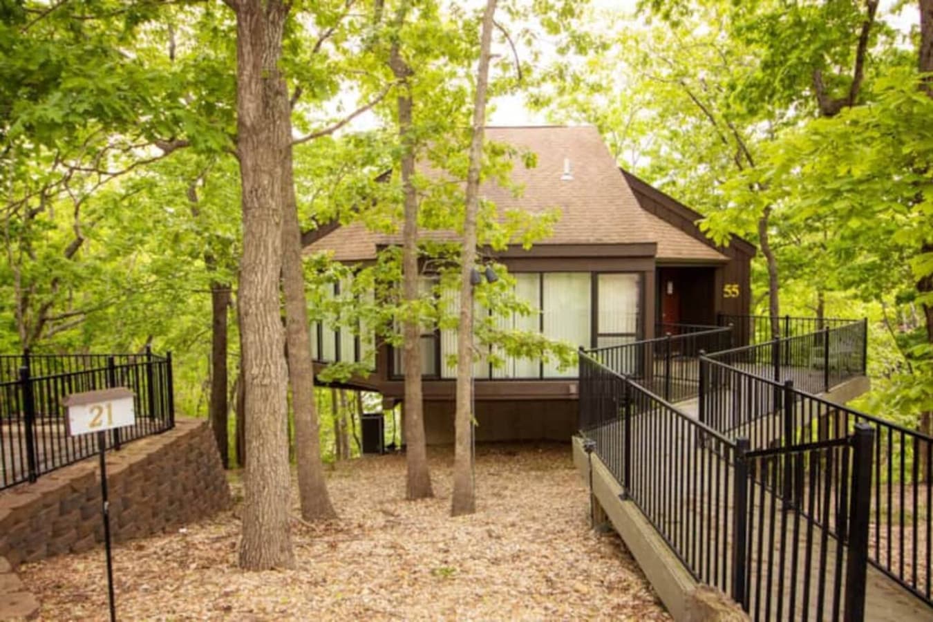 This modern elevated home offers a unique "treetop" living experience, blending seamlessly with the surrounding lush natural landscape. Multiple large windows allow for abundant natural light and scenic views, making this a bright and inviting retrea