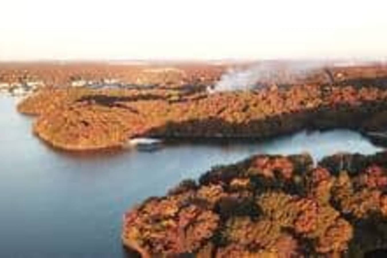 This stunning lakefront rental offers direct water access, perfect for boating and enjoying scenic views. Surrounded by lush greenery, it's an ideal retreat for those seeking tranquility and outdoor adventures.