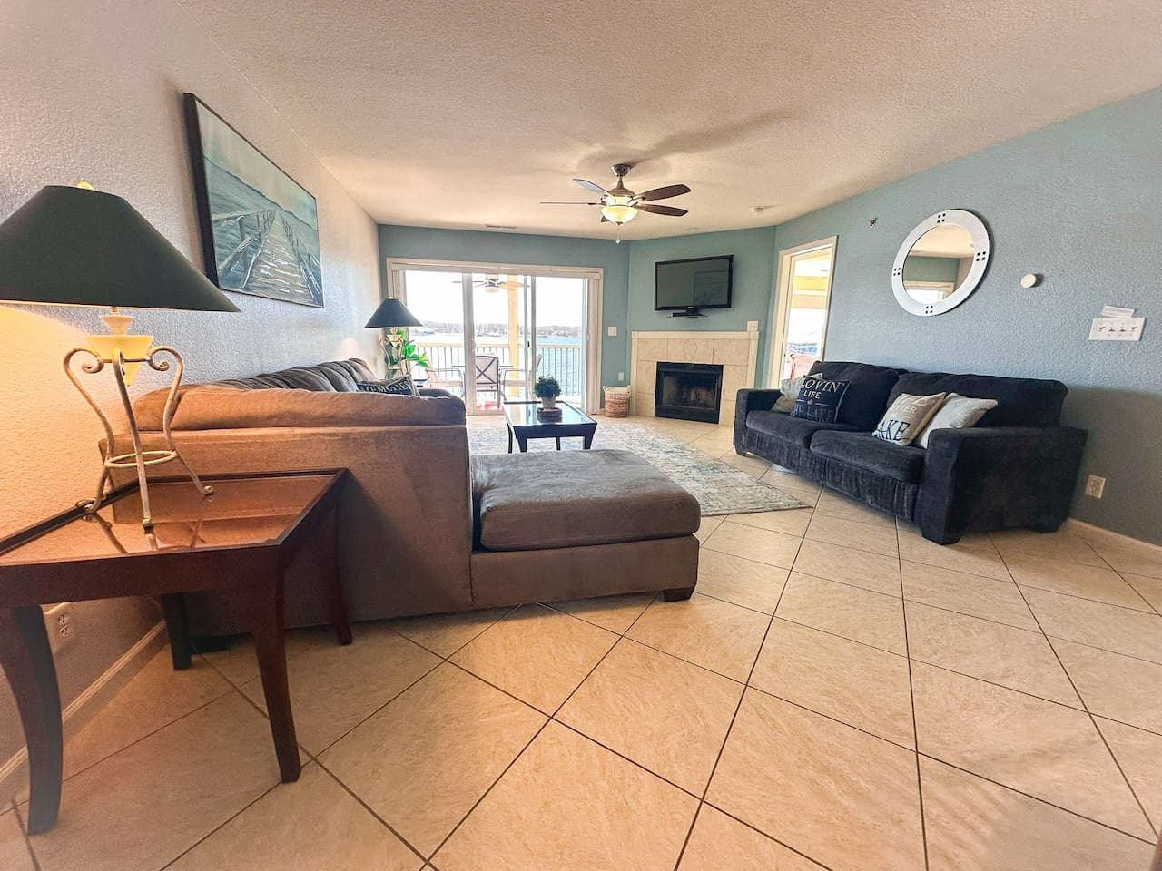 A beautifully designed living room featuring two comfortable sofas, lakeside decor, and a bright, airy feel—perfect for relaxing after a day on the water.