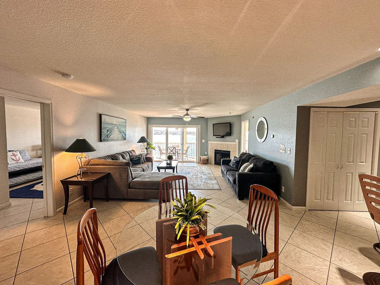 This bright and open living area seamlessly connects to a spacious dining space, making it ideal for entertaining. Enjoy relaxing evenings by the fireplace or step out onto the private balcony for fresh air and views.