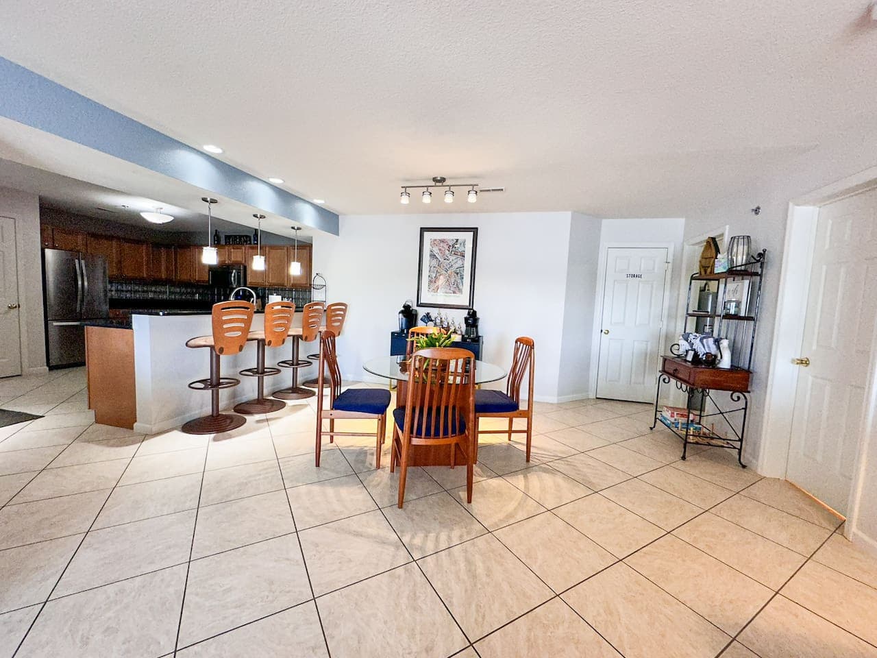 A fully equipped modern kitchen with stainless steel appliances, bar seating, and a large dining area—perfect for cooking and entertaining.