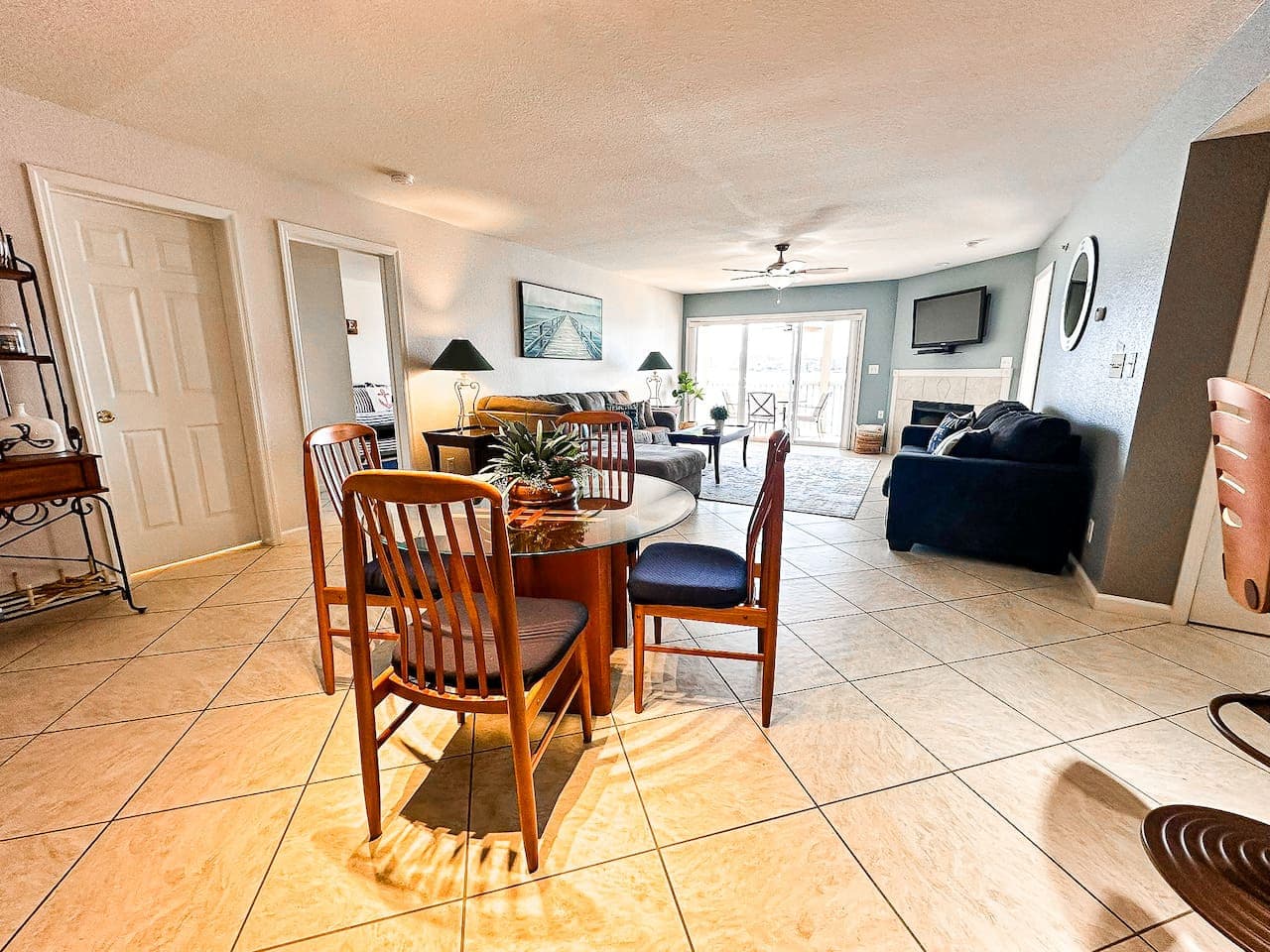 A welcoming space with plush seating, a fireplace, and lakefront views, making it ideal for relaxation and group gatherings.