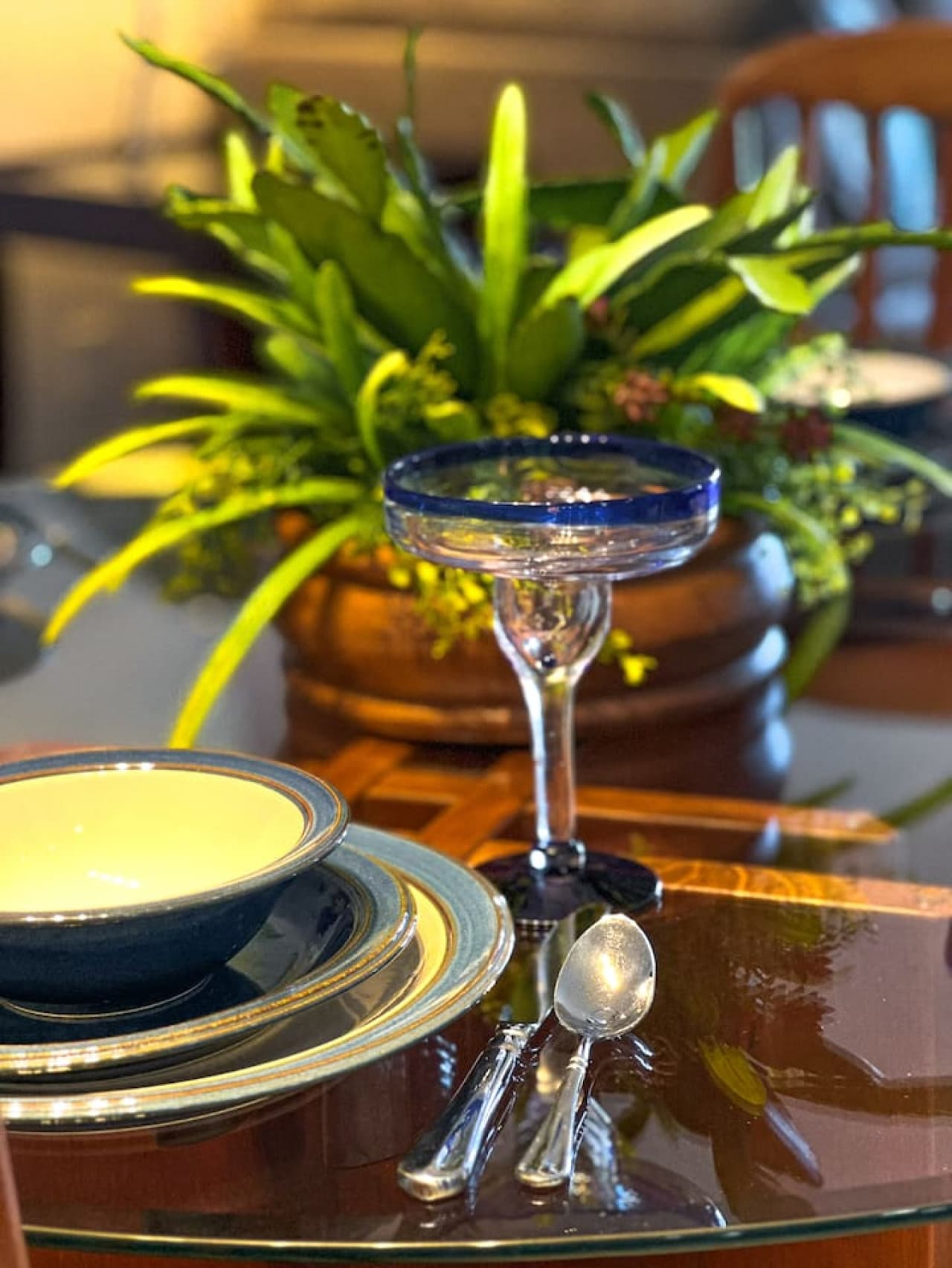 The dining experience is elevated with coastal-inspired tableware and glassware, enhancing the ambiance for a memorable dining experience.
