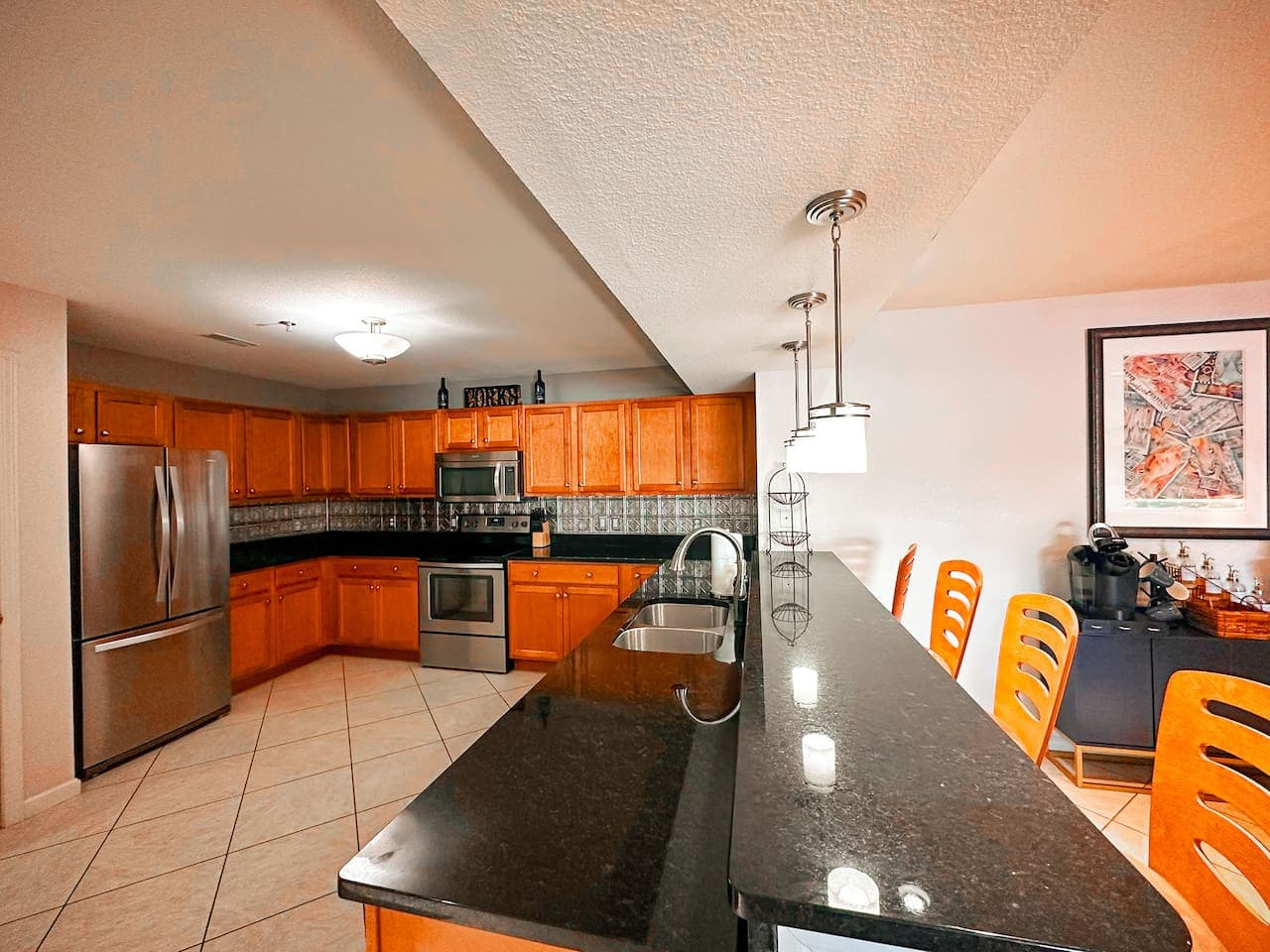 A modern and well-stocked kitchen, featuring a stainless steel refrigerator, oven, microwave, and dishwasher, ideal for cooking meals during your stay.