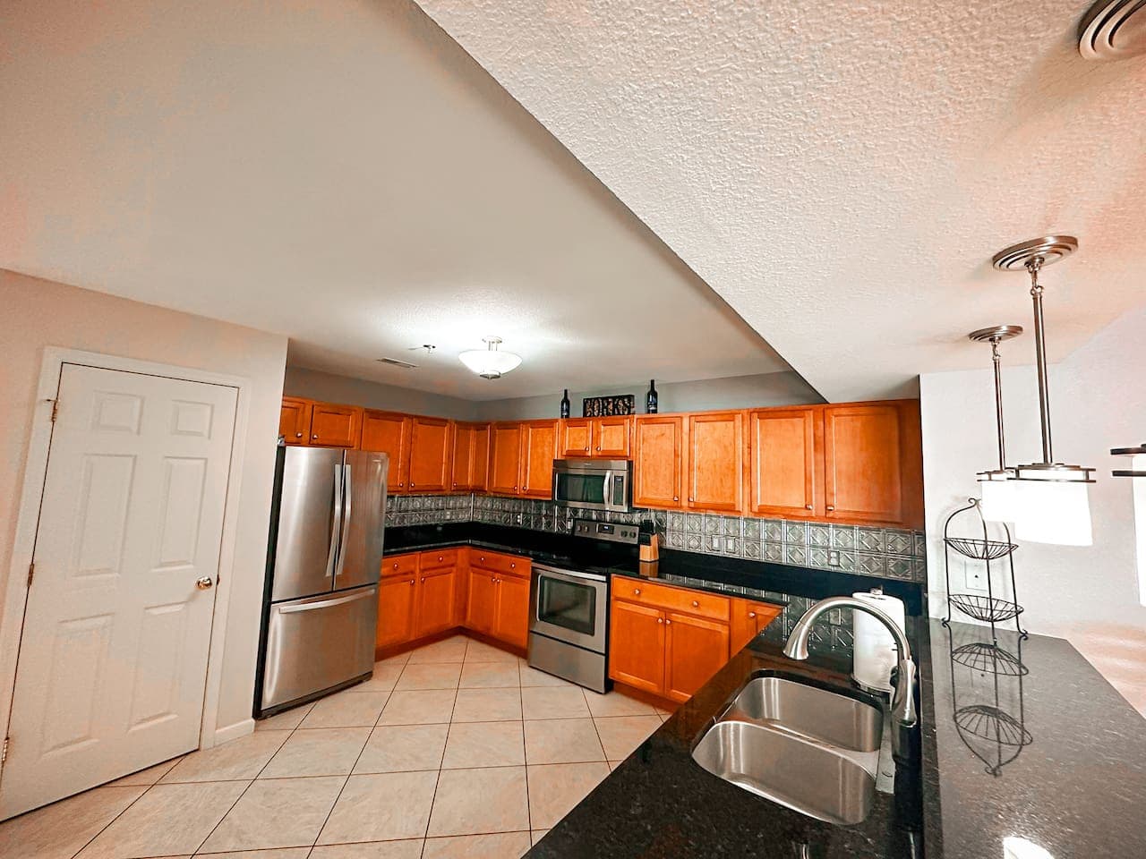 Featuring a double sink, dishwasher, oven, microwave, and full-sized refrigerator, making meal prep easy for guests.