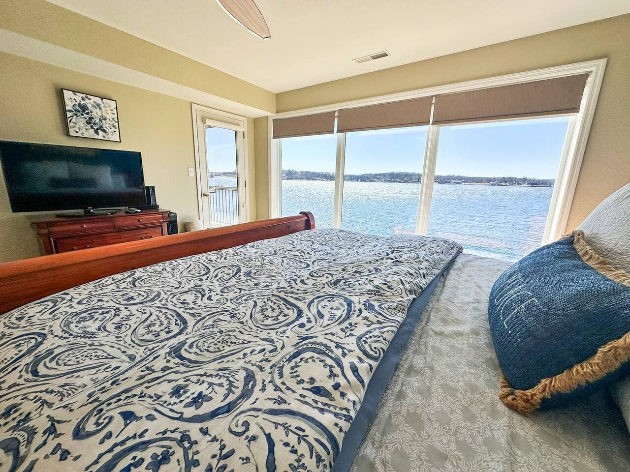 Wake up to the beauty of the lake in this spacious and inviting bedroom retreat.