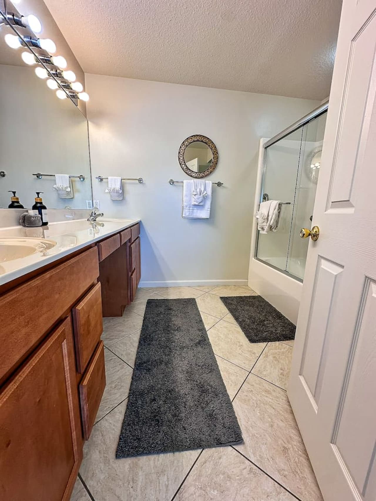 The master bathroom includes dual sinks, a large vanity mirror, and extra counter space, making it easy for couples or families to get ready.