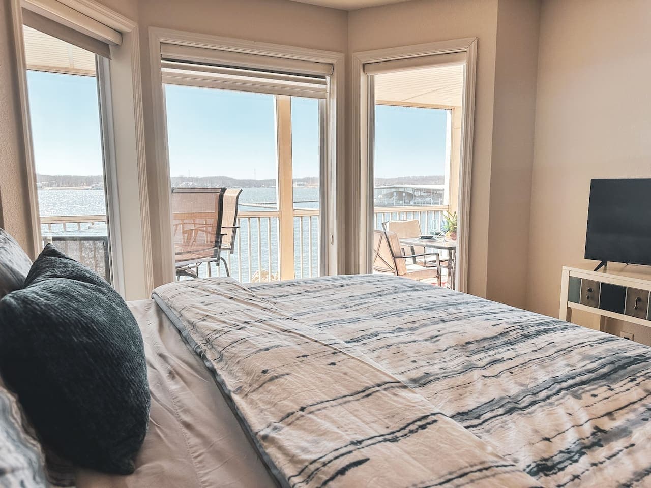 A second bedroom with ensuite bathroom and with large floor-to-ceiling windows frame breathtaking lake views, making this the perfect spot to relax, unwind, and enjoy the scenery.