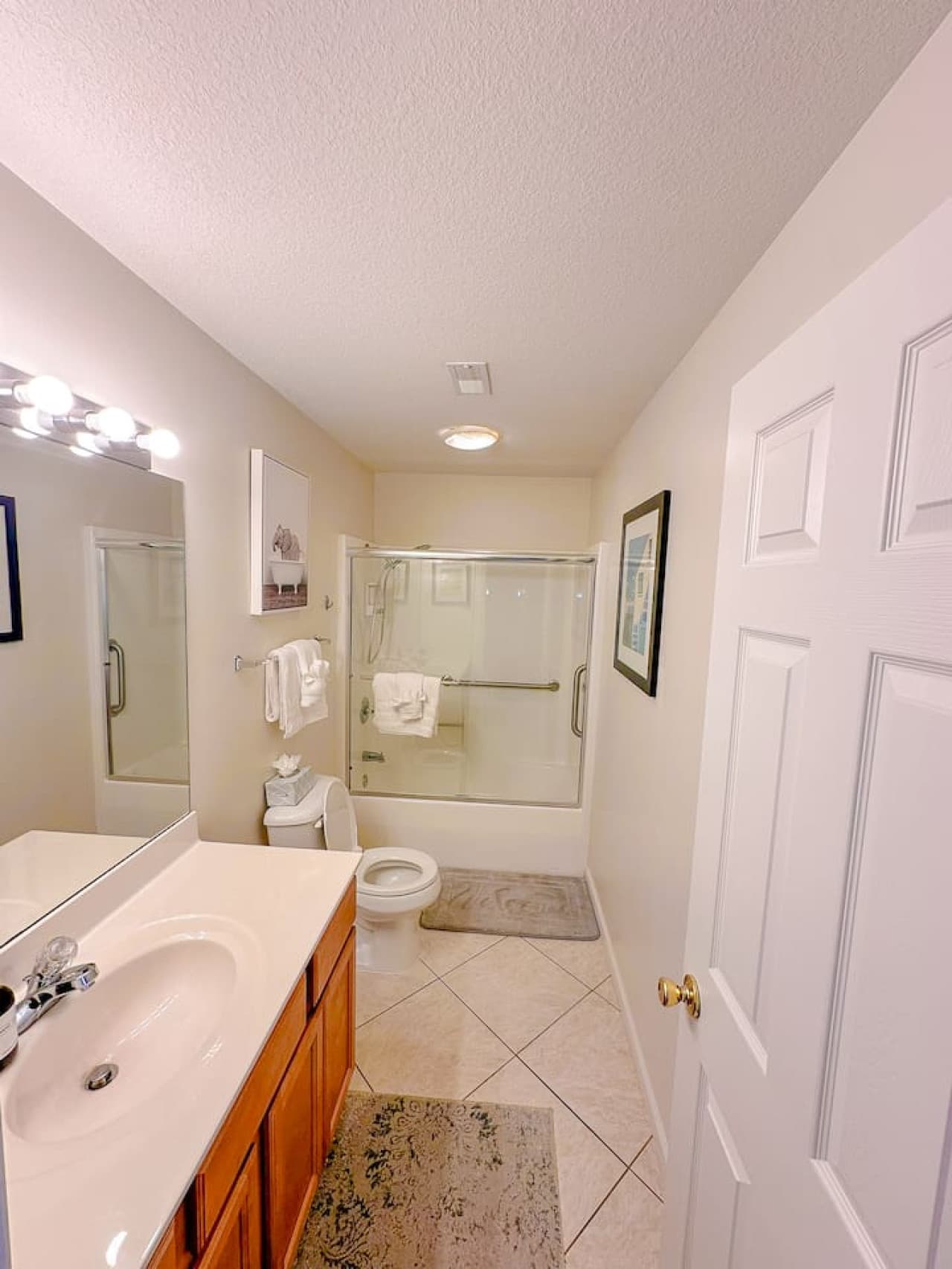 A spacious second full bathroom with a walk-in shower and grab bars, offering both comfort and convenience for guests.