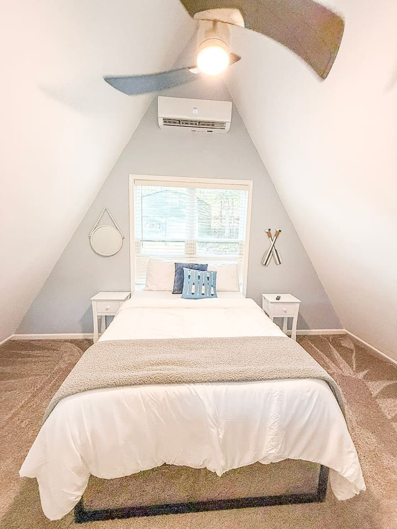 Loft level bedroom overlooking the living room with views of the trees.