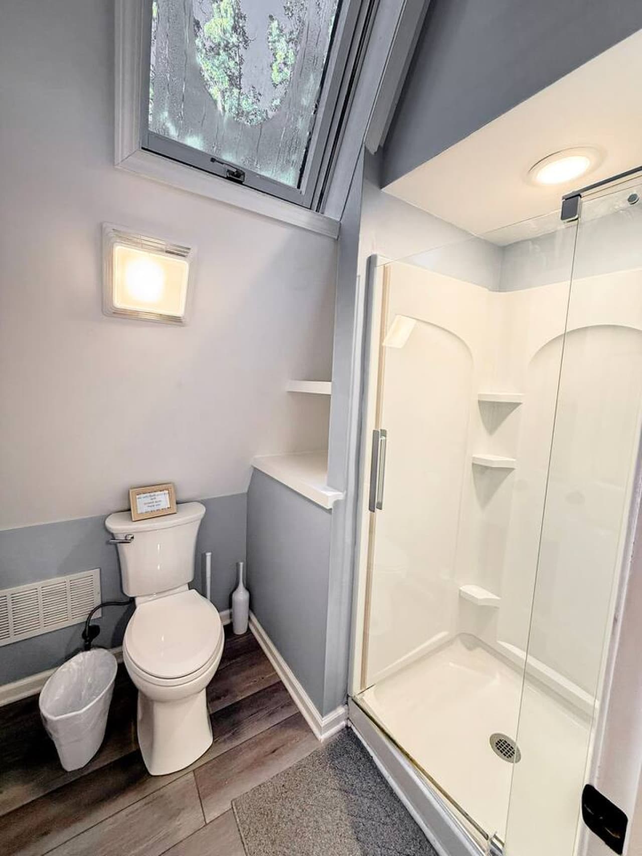 Upper level bathroom with walkin shower and toilet.