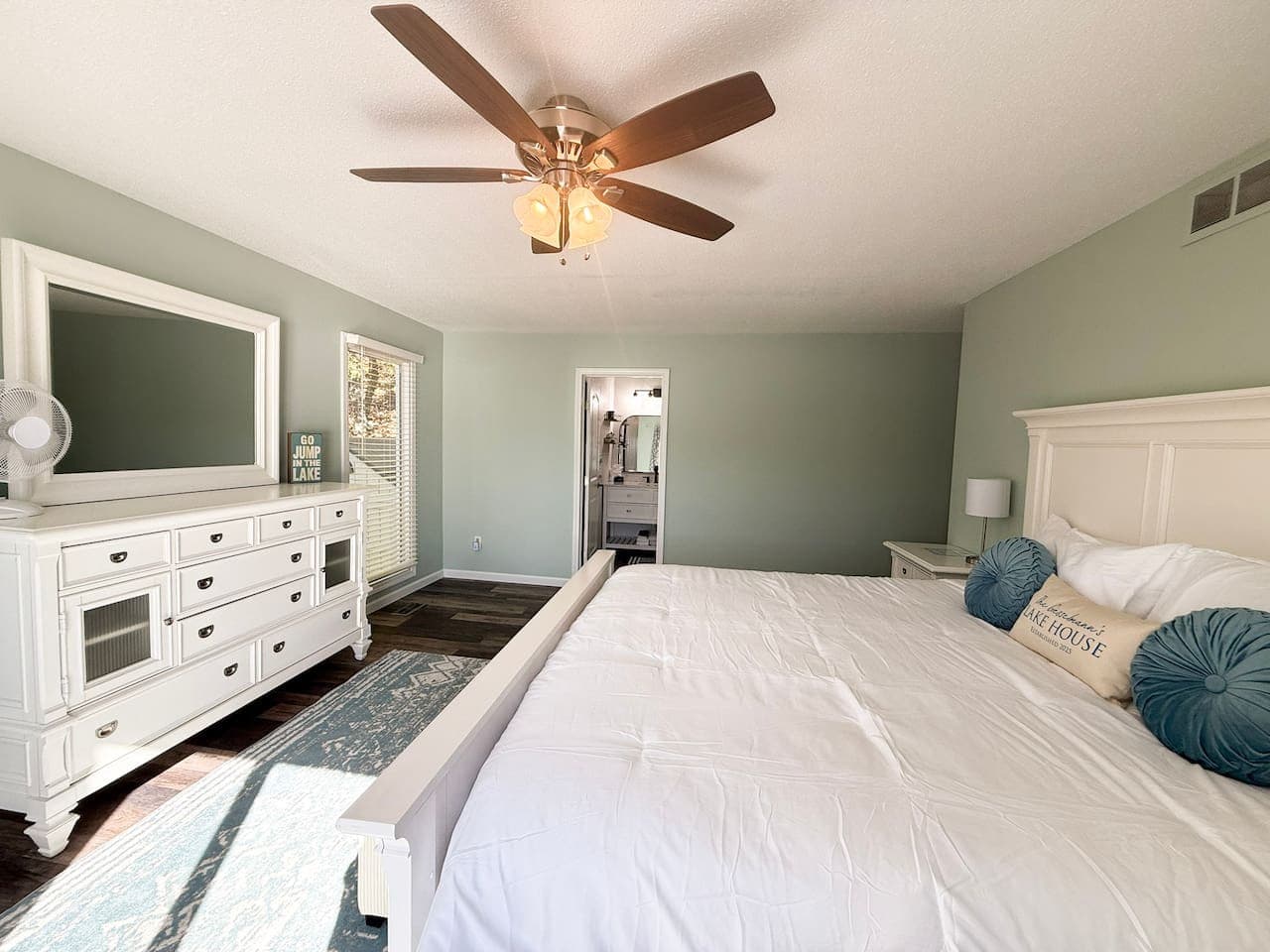 Bright master bedroom with king bed and modern coastal style.