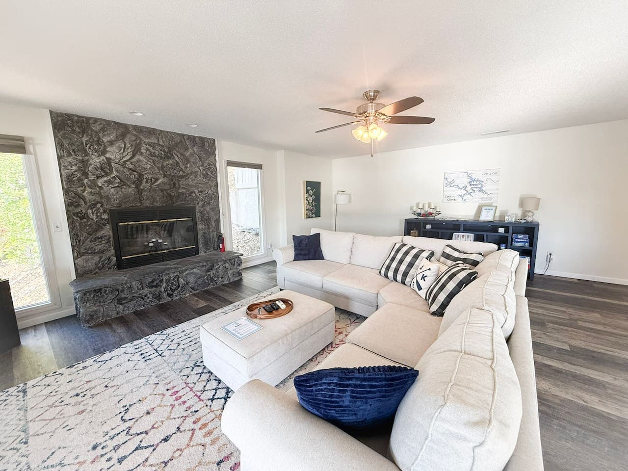 Cozy seating by a stone fireplace with modern décor.