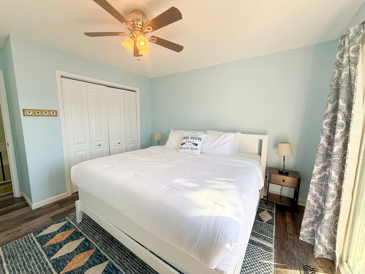 Cozy king bedroom with soft blue tones and modern décor