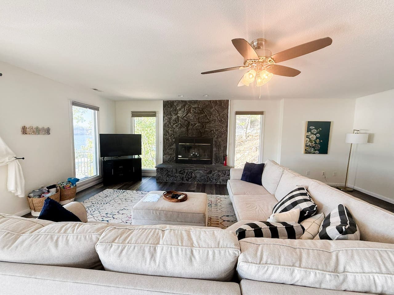 Cozy living space with stone fireplace and large sectional.
