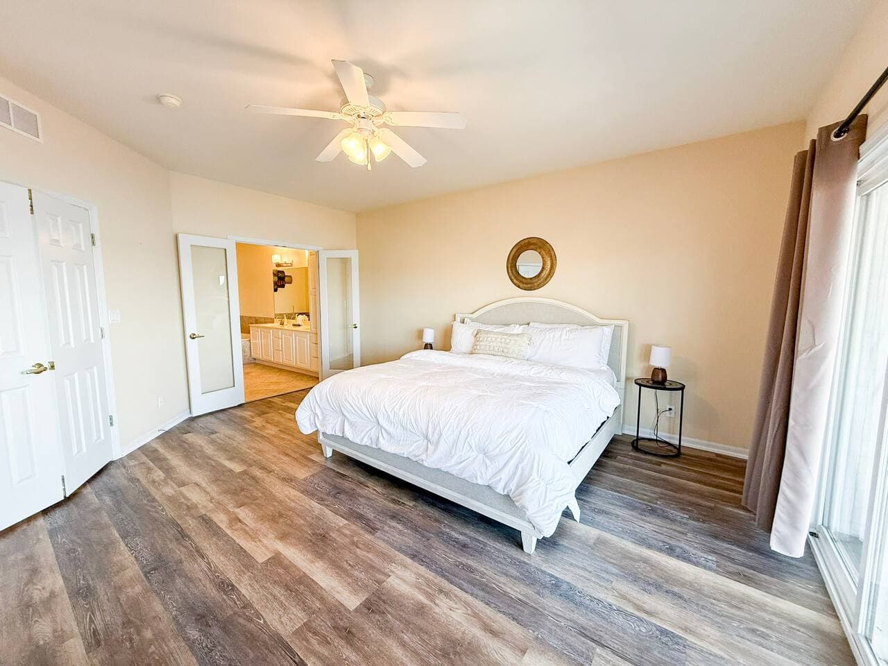 Recharge in this bright bedroom featuring a plush king bed, stylish furnishings, and plenty of space to stretch out.