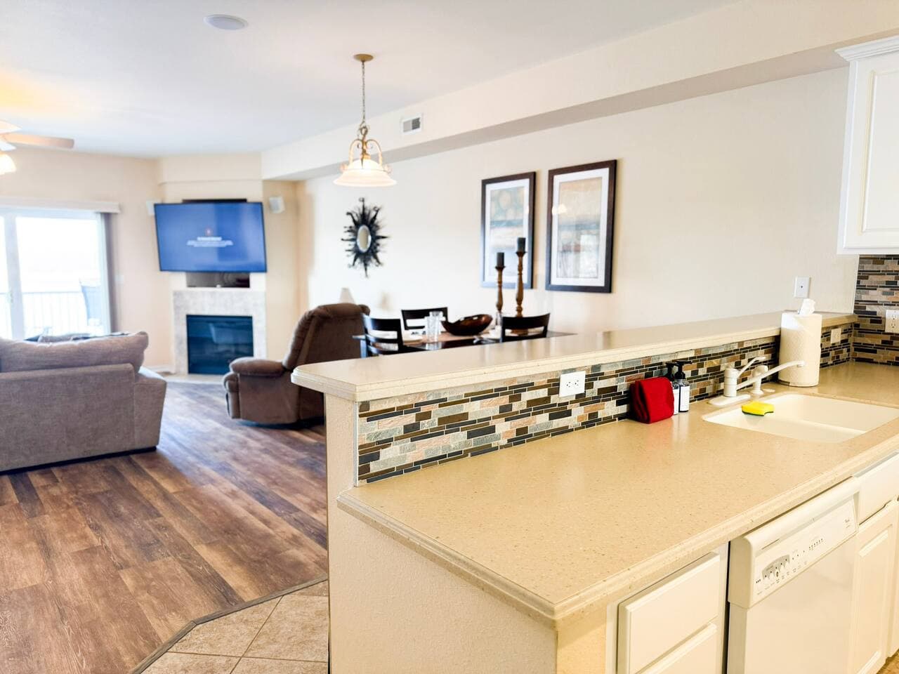 Enjoy a bright, open-concept living space with a modern kitchen bar, perfect for meals, conversation, and relaxing together.