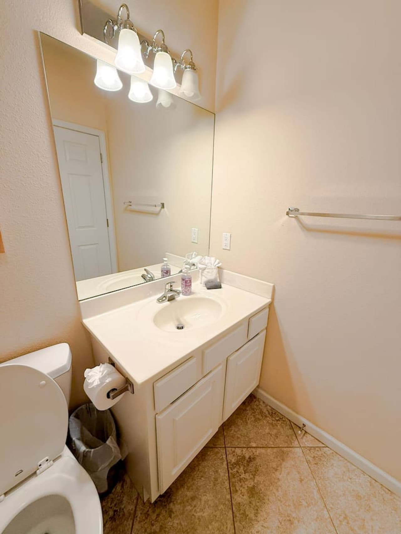 Refresh in this clean, bright bathroom with modern vanity and ample counter space, designed for comfort and convenience.