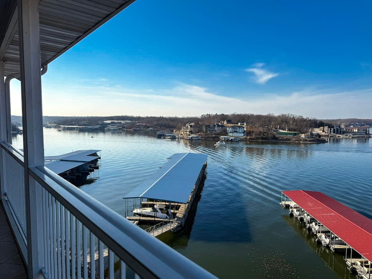 Take in breathtaking lake views from your private balcony, overlooking calm waters and nearby docks.