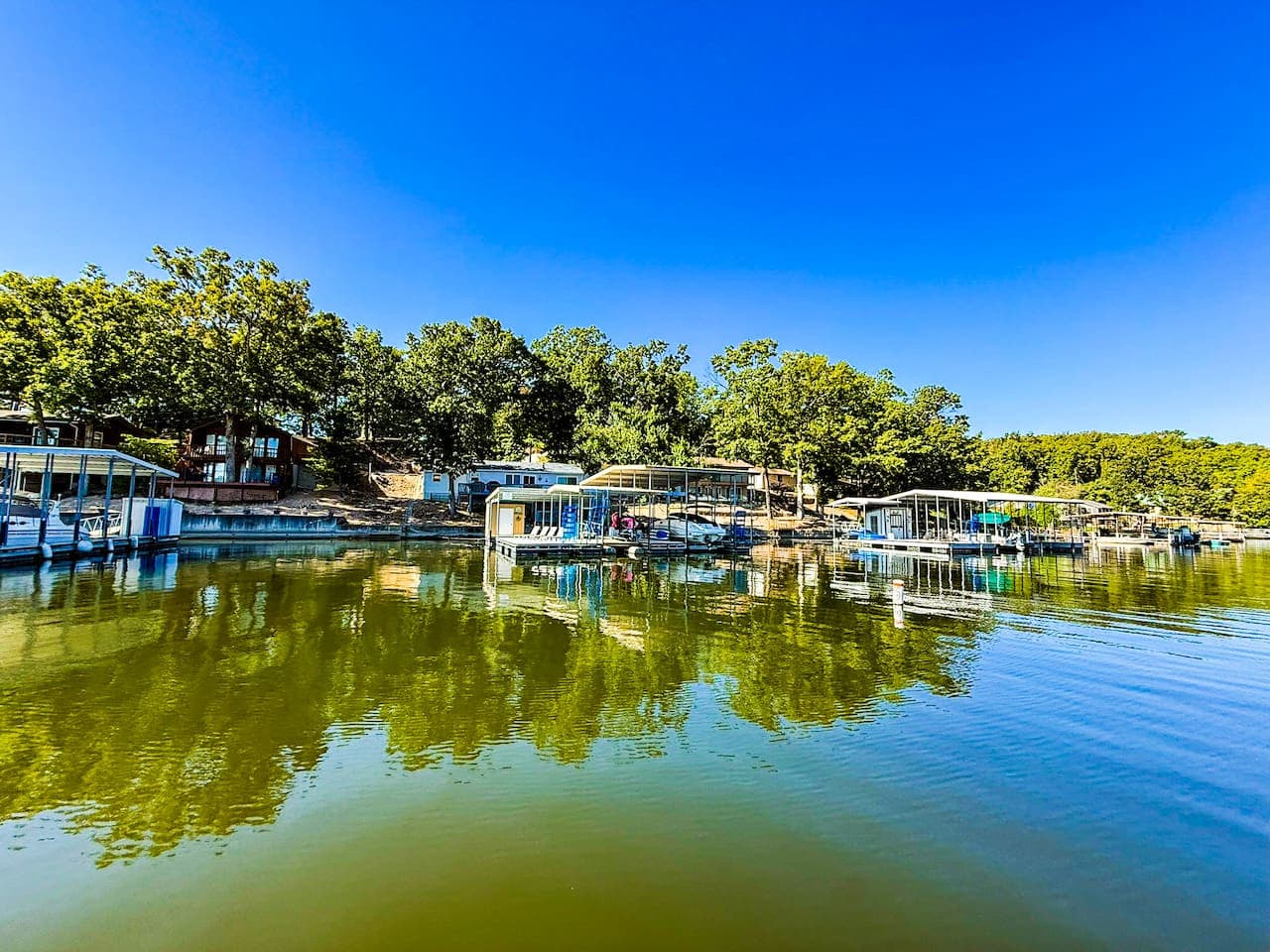 View of dock and house from the water.  Look at all that lake waiting for floatin' and fishing.