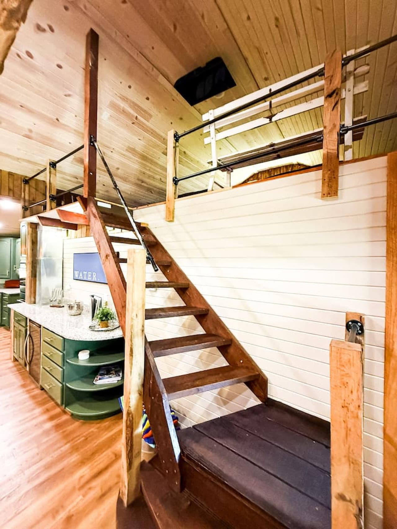 Charming staircase leads to a cozy loft overlooking the heart of the home.