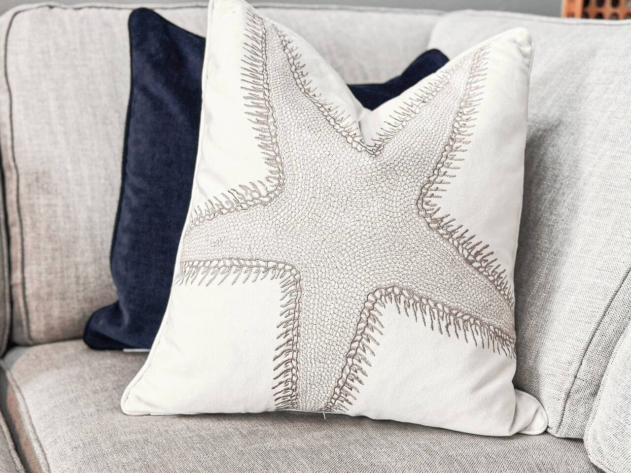 A starfish-themed pillow adds a coastal vibe to the cozy sofa.