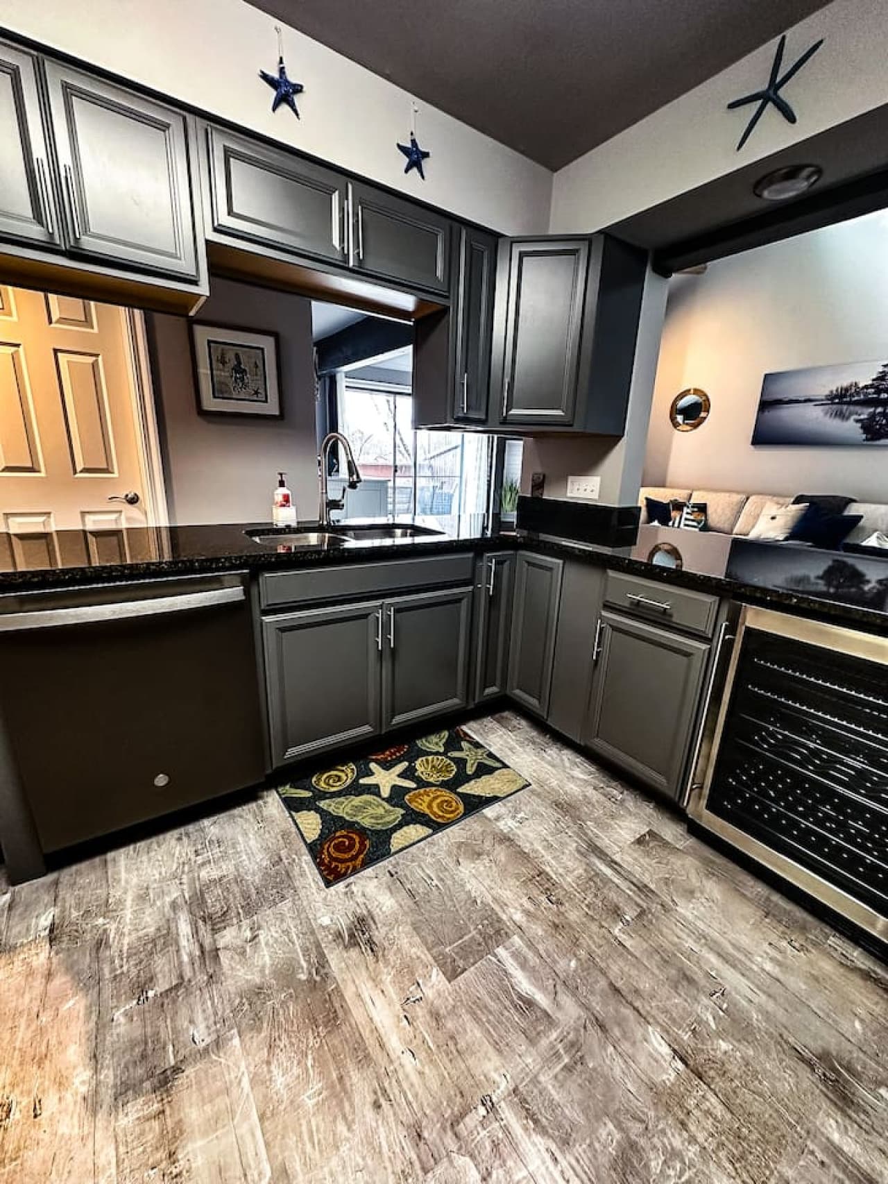 Modern gourmet kitchen with a sleek design, featuring stainless steel appliances, a wine fridge, and plenty of counter space.