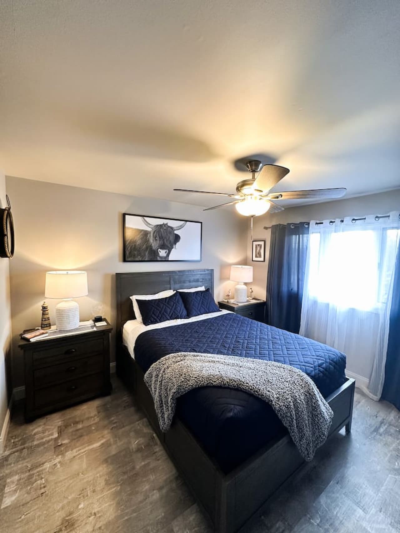 Sunlit bedroom with refined furnishings and a chic design for ultimate comfort.