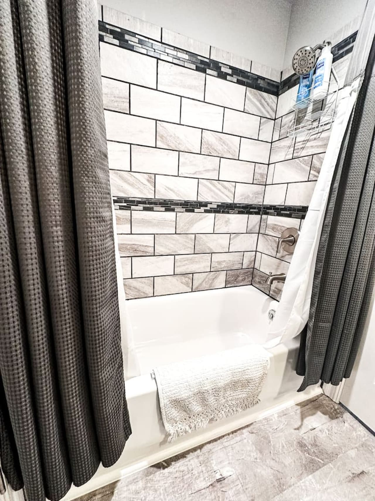 Luxurious bathtub with a beautifully tiled surround in the master bathroom for ultimate relaxation.