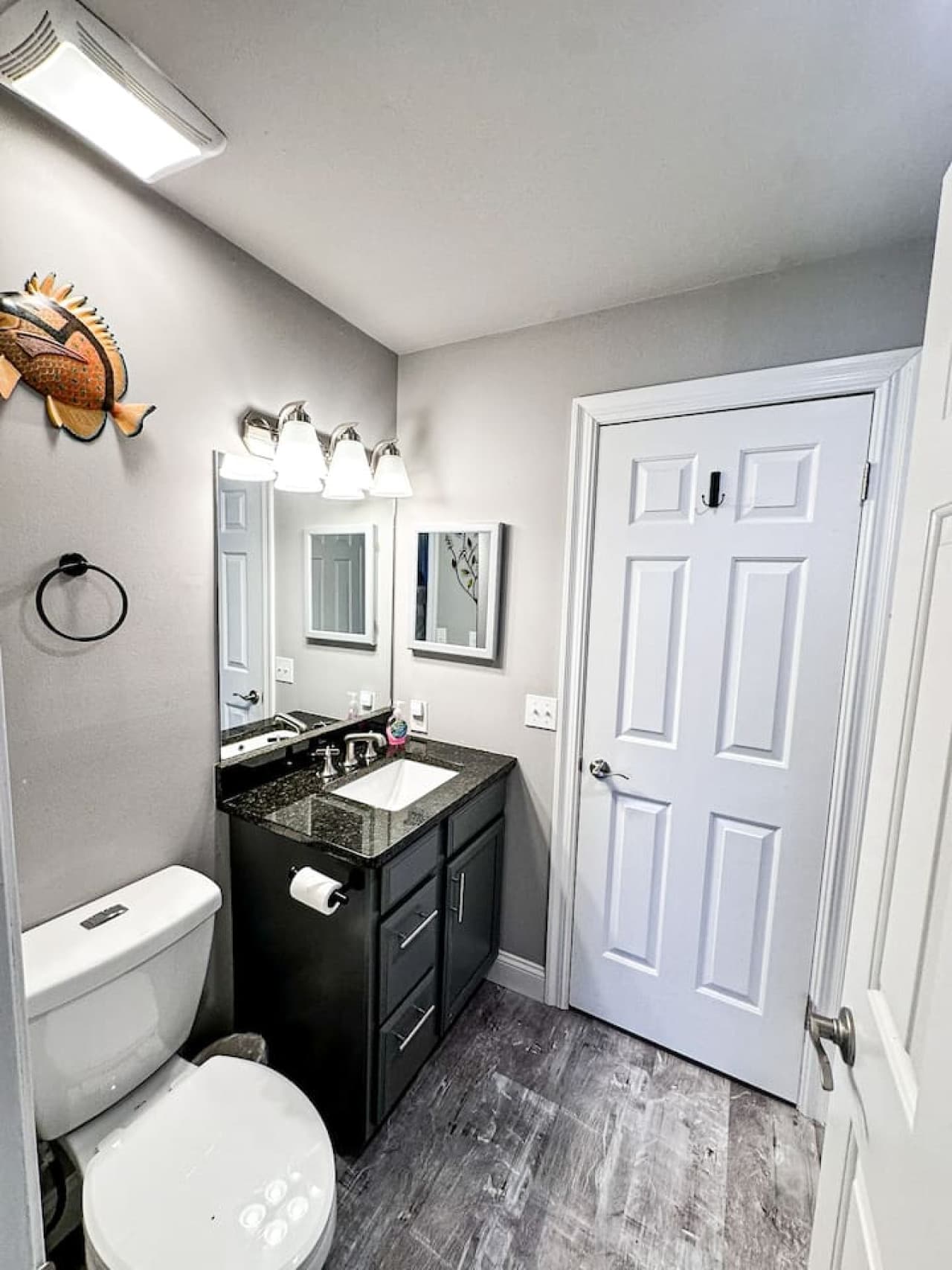 Bright and modern master bathroom with a granite countertop and elegant fixtures.