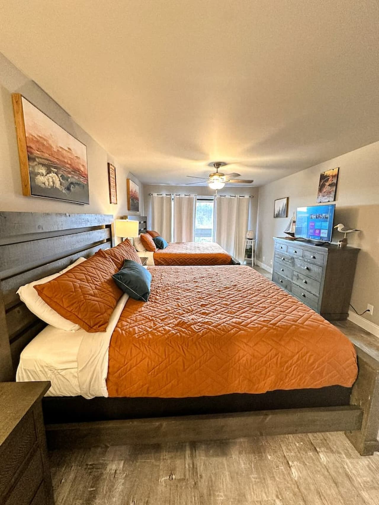 A spacious bedroom with two king-size beds, perfect for accommodating additional guests.