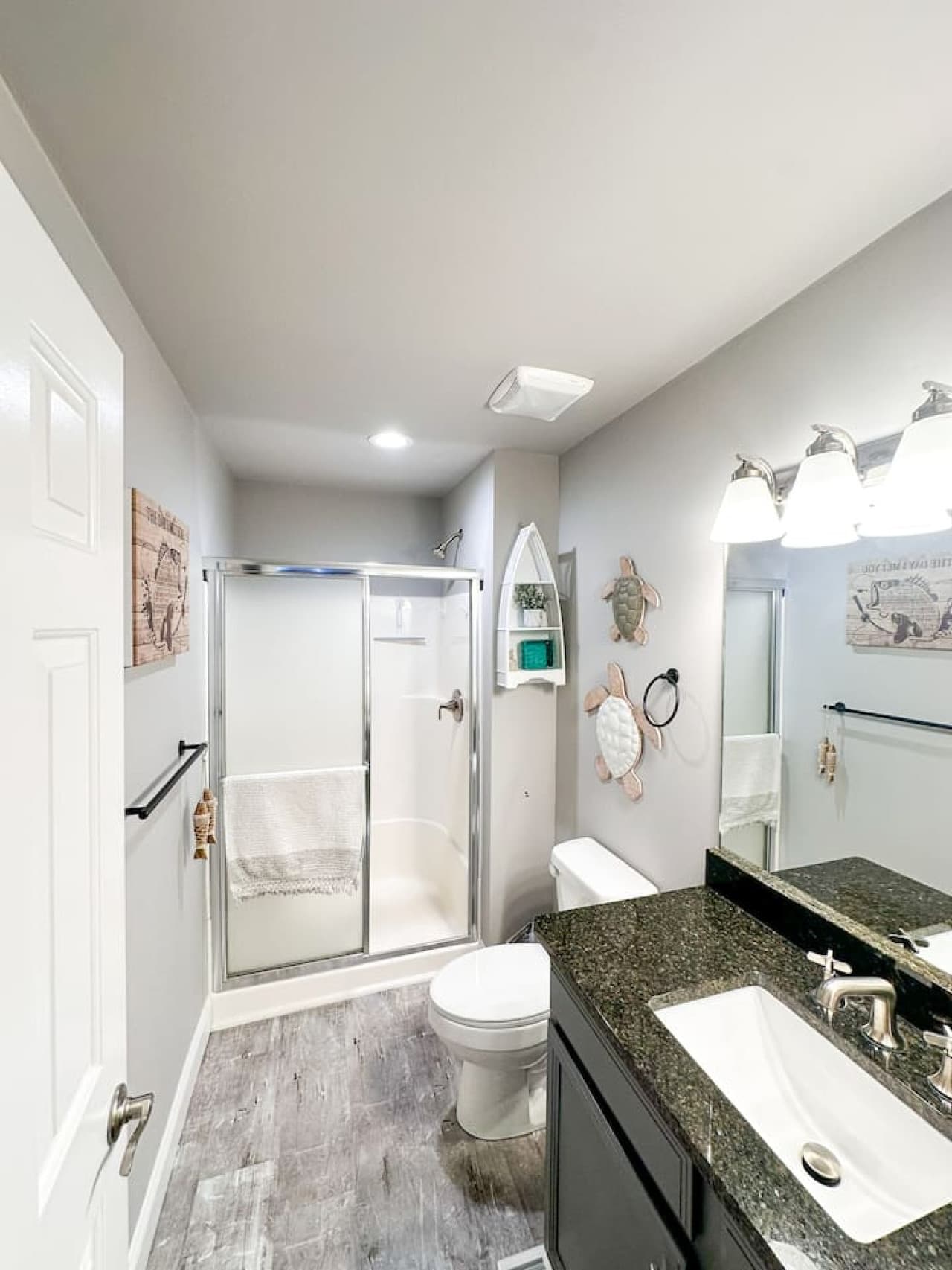 Walk-in Shower: Spacious walk-in shower with a frosted glass door for privacy.