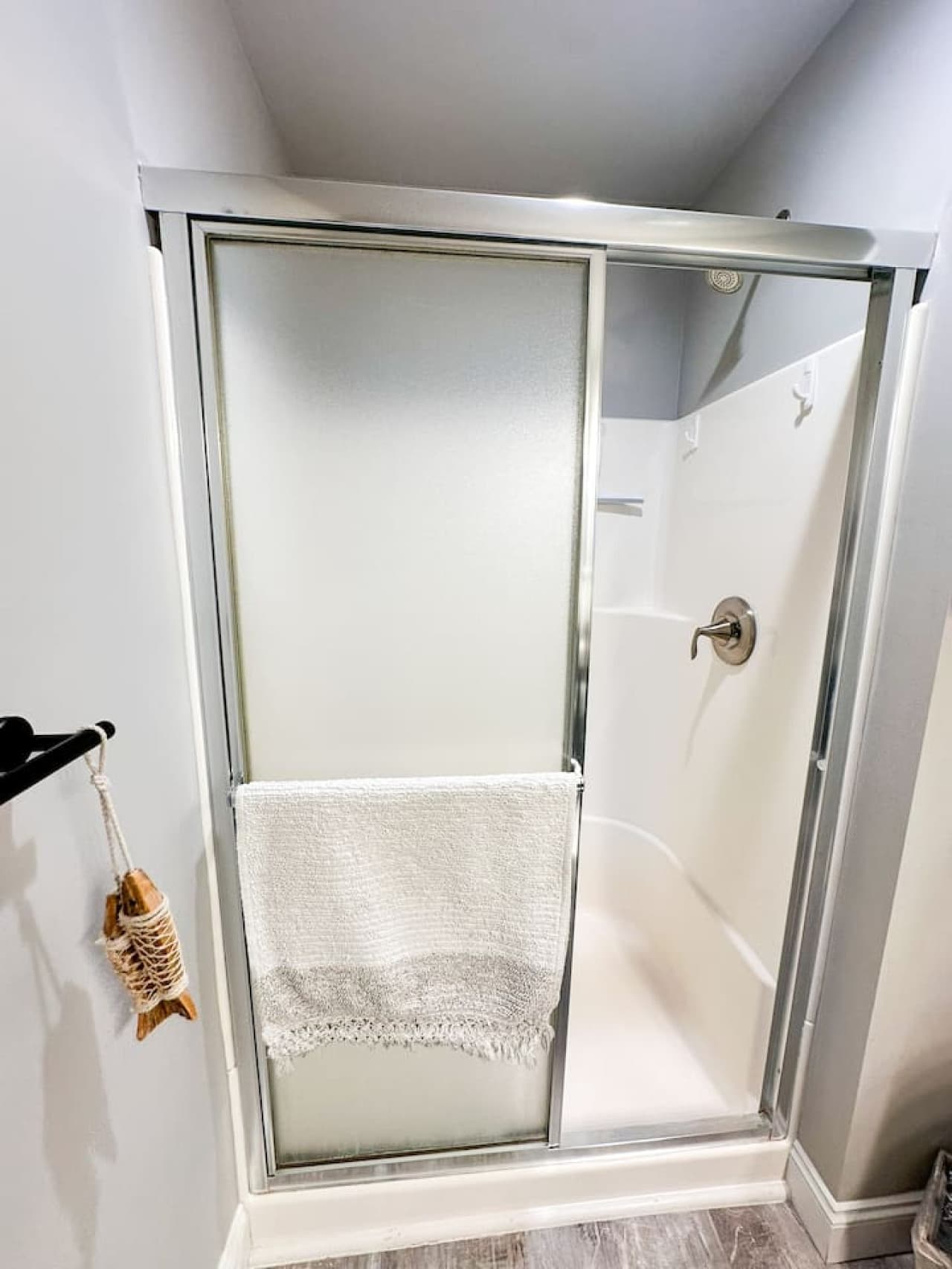 Bathroom Two: Features a sleek walk-in shower, granite countertops, and nautical decor for a relaxing retreat.