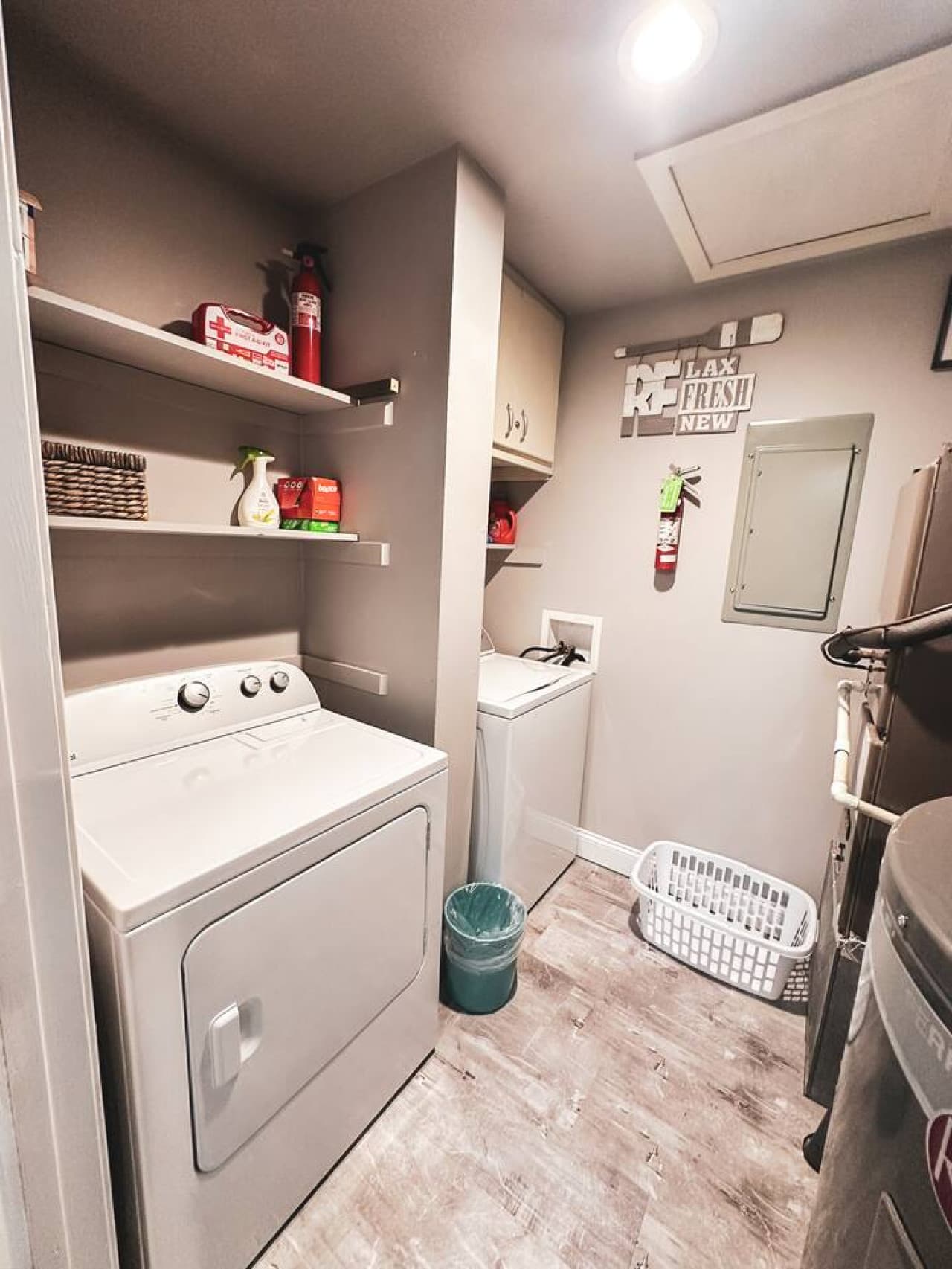 Spacious and fully equipped laundry room with washer, dryer, and ample storage for convenience.