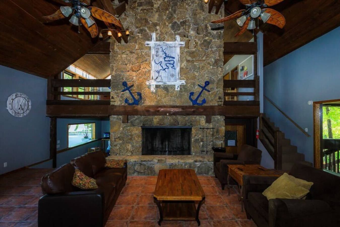 Cozy up by the fireplace in the rustic lounge area with nautical-themed decor.