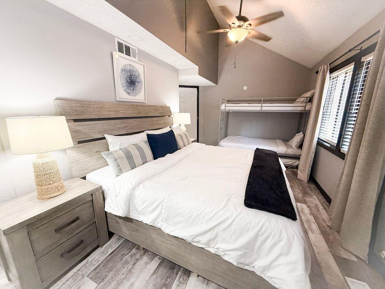 Inviting master bedroom with a king bed, vaulted ceiling, and plenty of natural light.
