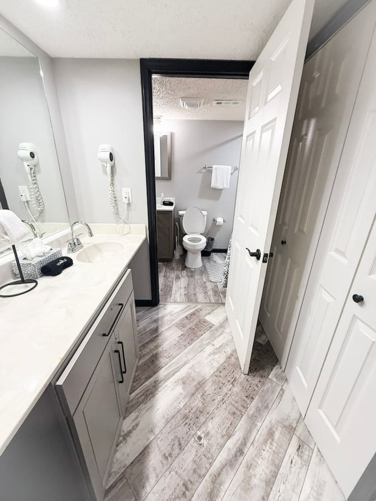 Modern bathroom with dual sinks, fresh towels, and all essentials for a comfortable stay.
