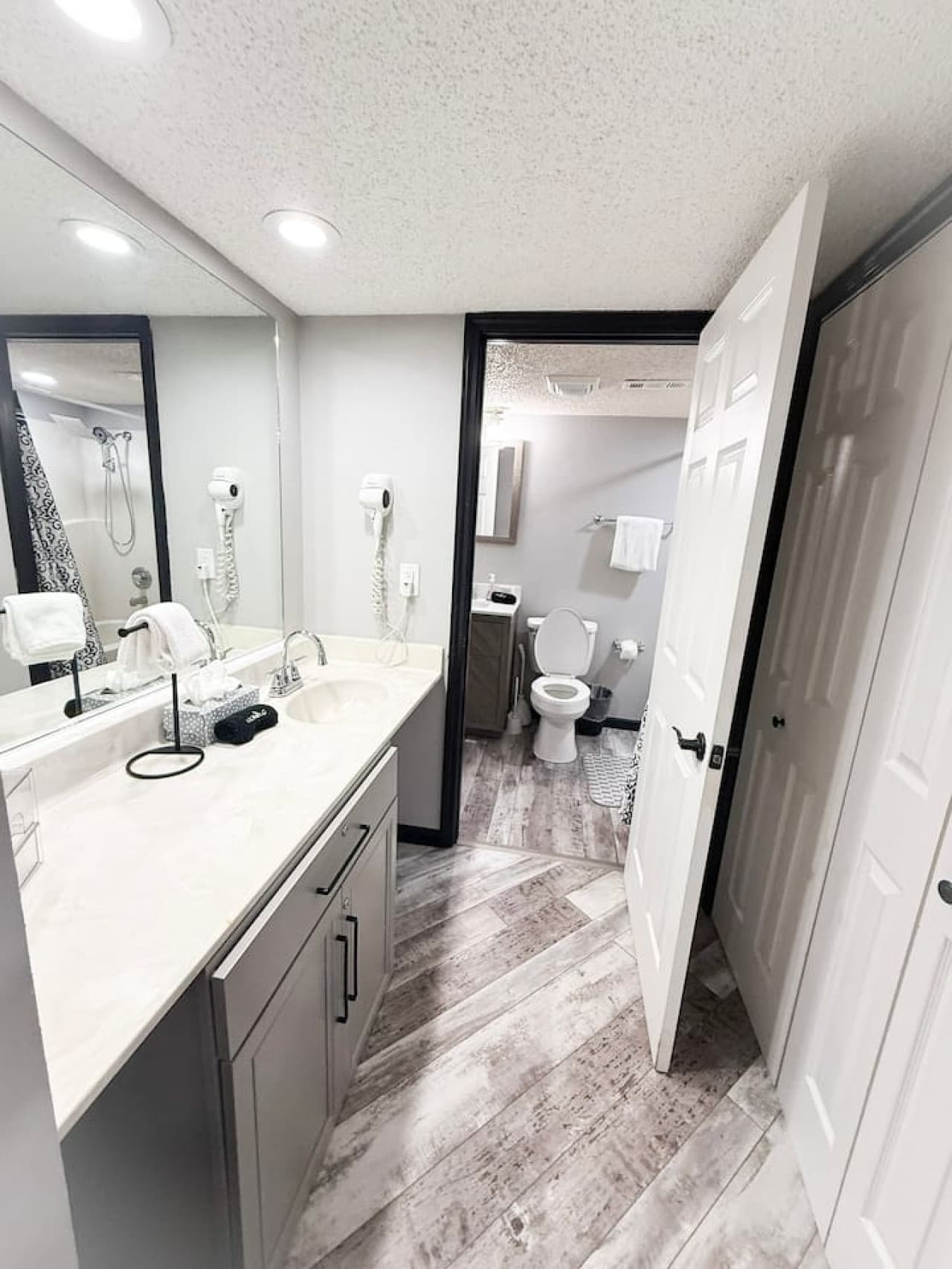 Clean and modern bathroom with double vanity and full amenities.