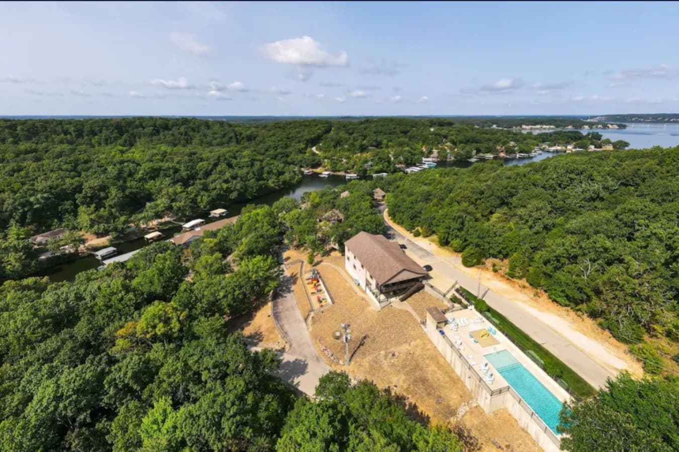 Scenic aerial view of the community with pool and lake access.